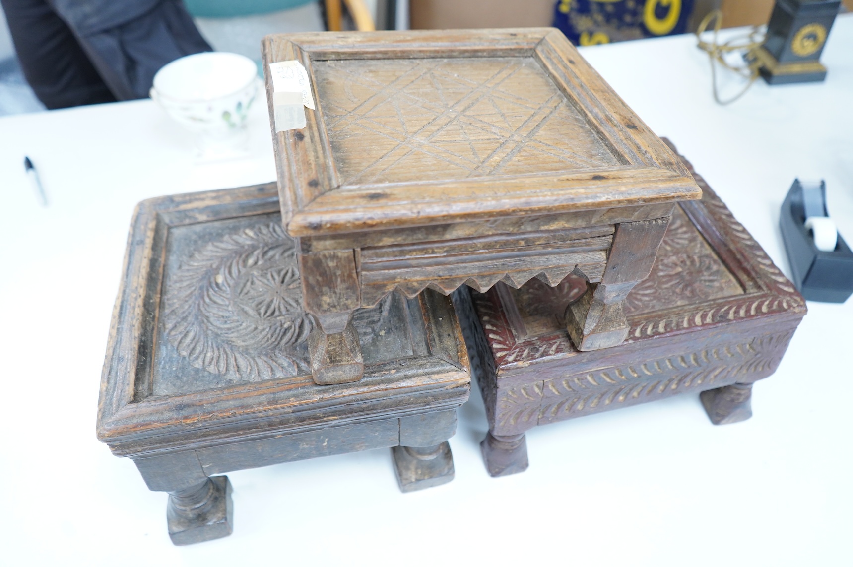 Three Indian carved wood stools or small tables, largest 27cm wide
